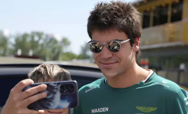 Aston Martin driver Lance Stroll of Canada arrives prior to the first free practice at the Enzo and Dino Ferrari racetrack, ahead the Italy's Emilia Romagna Formula One Grand Prix, in Imola, Italy, Friday, May 16, 2025. (AP Photo/Luca Bruno)