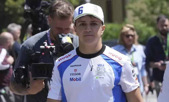 Racing Bulls driver Isack Hadjar of France arrives at the Dino and Enzo Ferrari racetrack, ahead the Italy's Emilia Romagna Formula One Grand Prix in Imola, Italy, Thursday, May 15, 2025. (AP Photo/Antonio Calanni)
