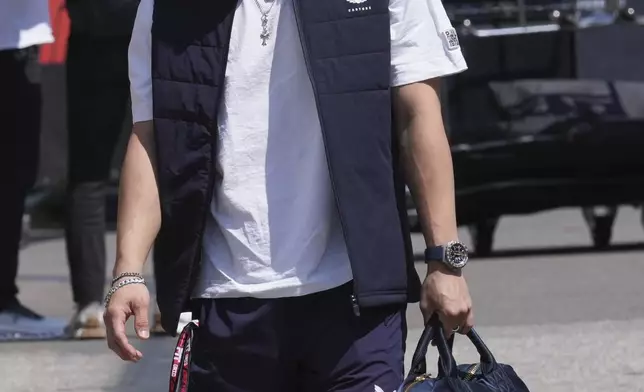 Red Bull driver Yuki Tsunoda of Japan arrives at the Dino and Enzo Ferrari racetrack, ahead the Italy's Emilia Romagna Formula One Grand Prix in Imola, Italy, Thursday, May 15, 2025. (AP Photo/Antonio Calanni)
