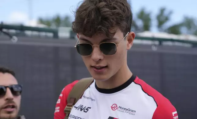 Haas driver Oliver Bearman of Britain arrives prior to the first free practice at the Enzo and Dino Ferrari racetrack, ahead the Italy's Emilia Romagna Formula One Grand Prix, in Imola, Italy, Friday, May 16, 2025. (AP Photo/Luca Bruno)