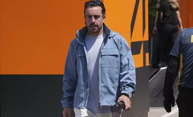 Aston Martin driver Fernando Alonso of Spain arrives for the first free practice at the Enzo and Dino Ferrari racetrack, ahead the Italy's Emilia Romagna Formula One Grand Prix, in Imola, Italy, Friday, May 16, 2025. (AP Photo/Antonio Calanni)
