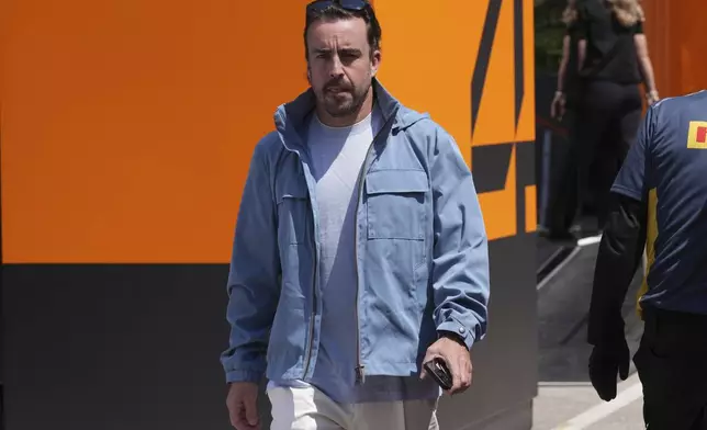 Aston Martin driver Fernando Alonso of Spain arrives at the Dino and Enzo Ferrari racetrack, ahead the Italy's Emilia Romagna Formula One Grand Prix in Imola, Italy, Thursday, May 15, 2025. (AP Photo/Antonio Calanni)