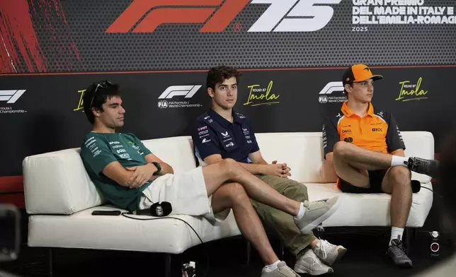 Alpine driver Franco Colapinto of Argentina, center, is flanked by Aston Martin driver Lance Stroll of Canada , left, and McLaren driver Oscar Piastri of Australia during a news conference at the Enzo and Dino Ferrari racetrack, ahead the Italy's Emilia Romagna Formula One Grand Prix in Imola, Italy, Thursday, May 15, 2025. (AP Photo/Luca Bruno)