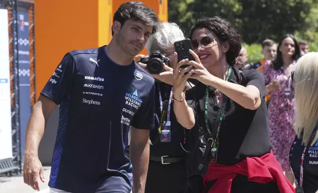 Williams driver Carlos Sainz of Spain, left, arrives at the Dino and Enzo Ferrari racetrack, in Imola, Italy, Thursday, May 15, 2025. (AP Photo/Antonio Calanni)