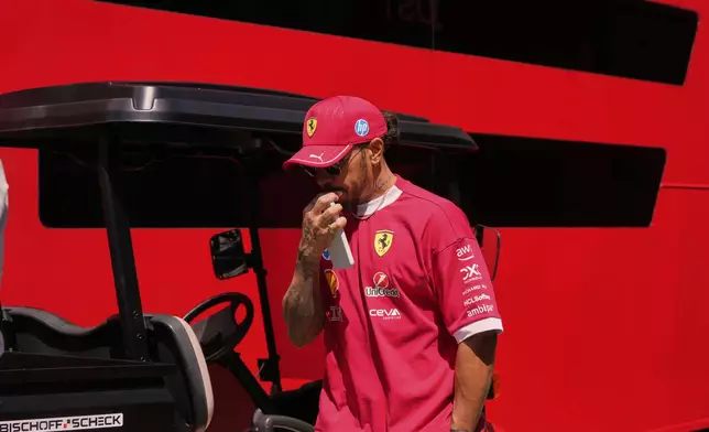 Ferrari driver Lewis Hamilton of Britain arrives prior to the first free practice at the Enzo and Dino Ferrari racetrack, ahead the Italy's Emilia Romagna Formula One Grand Prix, in Imola, Italy, Friday, May 16, 2025. (AP Photo/Luca Bruno)