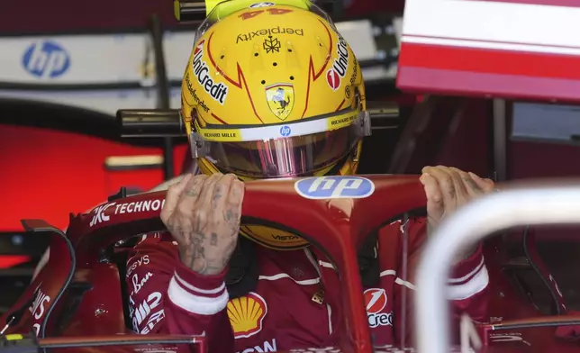 Ferrari driver Lewis Hamilton of Britain gets ready during the first free practice at the Enzo and Dino Ferrari racetrack, ahead the Italy's Emilia Romagna Formula One Grand Prix, in Imola, Italy, Friday, May 16, 2025. (AP Photo/Antonio Calanni)