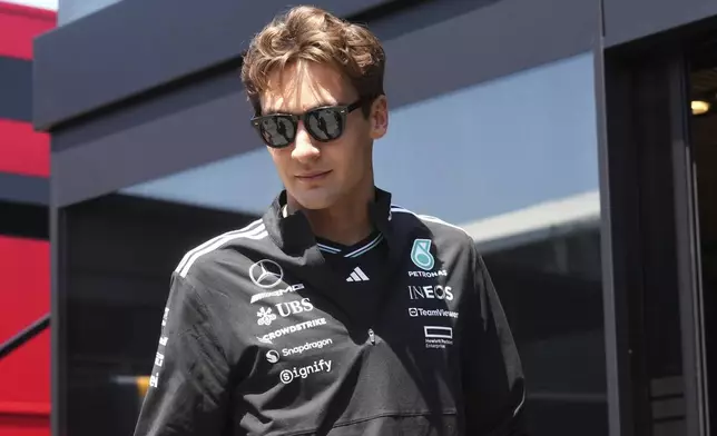 Mercedes driver George Russell of Britain arrives at the Dino and Enzo Ferrari racetrack, in Imola, Italy, Thursday, May 15, 2025. (AP Photo/Antonio Calanni)