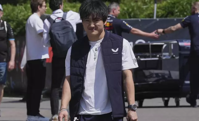 Red Bull driver Yuki Tsunoda of Japan arrives for the first free practice at the Enzo and Dino Ferrari racetrack, ahead the Italy's Emilia Romagna Formula One Grand Prix, in Imola, Italy, Friday, May 16, 2025. (AP Photo/Antonio Calanni)