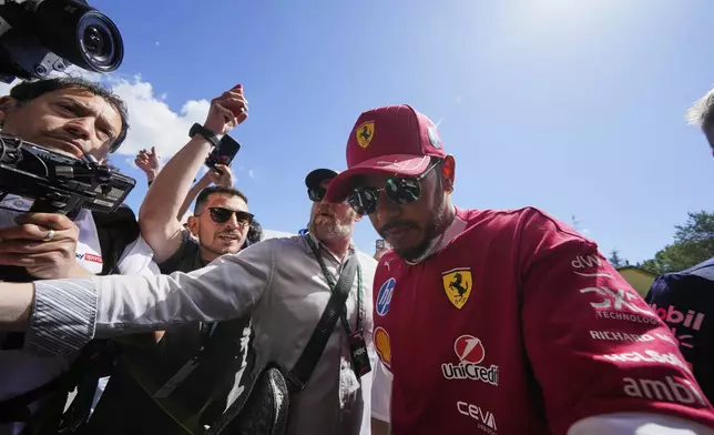Ferrari driver Lewis Hamilton of Britain arrives prior to the first free practice at the Enzo and Dino Ferrari racetrack, ahead the Italy's Emilia Romagna Formula One Grand Prix, in Imola, Italy, Friday, May 16, 2025. (AP Photo/Luca Bruno)