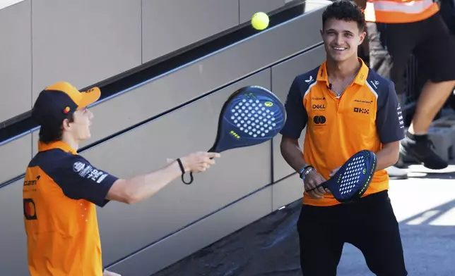 Oscar Piastri, of Australia, left, and Lando Norris, of United Kingdom, play padel at the Barcelona Catalunya racetrack in Montmelo, near Barcelona, Spain, Thursday May 29, 2025. The Spanish Grand Prix Formula One race will be held on Sunday. (AP Photo/Joan Monfort)