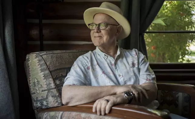 Joe Johnston, the founder of Agritopia, a community nestled around a plot of agricultural land, poses for a portrait inside his office April 22, 2025, in Gilbert, Ariz. (AP Photo/Annika Hammerschlag)