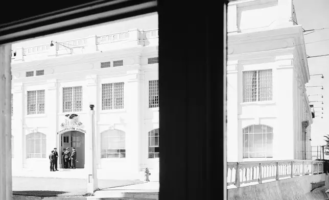 FILE - The administration building of the Alcatraz Federal Penitentiary is photographed through the doorway of the warden's home on the south end of Alcatraz Island in San Francisco Bay, California, March 13, 1956. (AP Photo/Ernest K. Bennett, File)