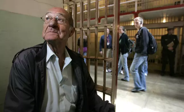 FILE - Darwin Coon, a former inmate who spent four years at the Alcatraz Federal Penitentiary for bank robbery, sits in his former cell at the prison in the San Francisco Bay, California, April 30, 2007. Coon wrote a book about his experiences on the island and was among the last inmates to the leave the island in 1962. (AP Photo/Eric Risberg, File)