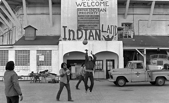 FILE - Native Americans play ball at the main dock during their occupation of Alcatraz Island in San Francisco Bay, California, Nov. 26, 1969. (AP Photo/File)