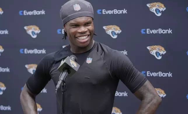 Jacksonville Jaguars wide receiver Travis Hunter speaks with reporters after practice at the NFL football team's rookie minicamp, Saturday, May 10, 2025, in Jacksonville, Fla. (AP Photo/John Raoux)