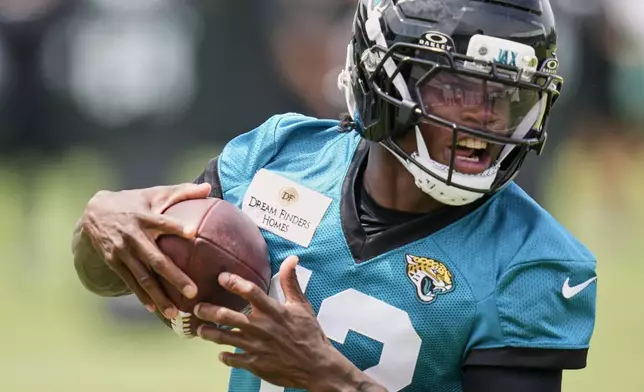 Jacksonville Jaguars wide receiver Travis Hunter makes a reception during the NFL football team's rookie minicamp, Saturday, May 10, 2025, in Jacksonville, Fla. (AP Photo/John Raoux)