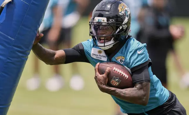 Jacksonville Jaguars wide receiver Travis Hunter performs a drill during the NFL football team's rookie minicamp, Saturday, May 10, 2025, in Jacksonville, Fla. (AP Photo/John Raoux)