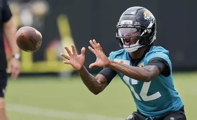 Jacksonville Jaguars wide receiver Travis Hunter makes a reception during the NFL football team's rookie minicamp, Saturday, May 10, 2025, in Jacksonville, Fla. (AP Photo/John Raoux)