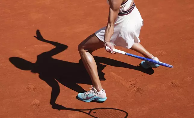 Serbia's Olga Danilovic casts her shadow on the court as she returns the ball to Aryna Sabalenka of Belarus during their third round match of the French Tennis Open, at the Roland-Garros stadium, in Paris, Friday, May 30, 2025. (AP Photo/Lindsey Wasson)