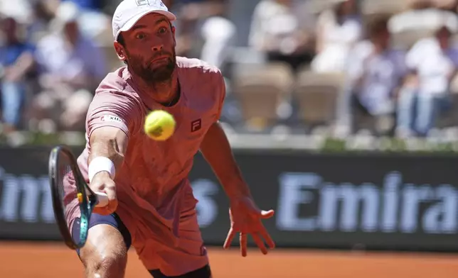 France's Quentin Halys returns the ball to Denmark's Holger Rune during their third round match of the French Tennis Open, at the Roland-Garros stadium, in Paris, Friday, May 30, 2025. (AP Photo/Lindsey Wasson)