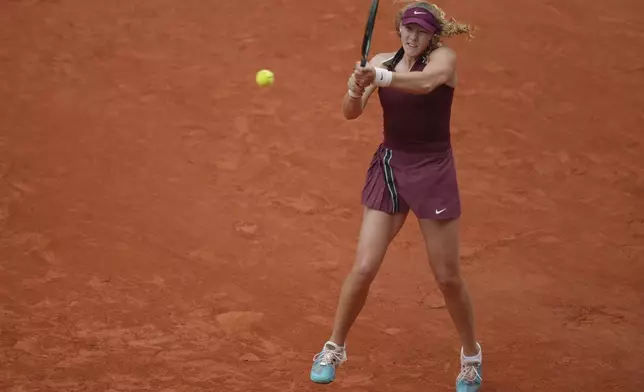 Russia's Mirra Andreeva returns the ball to Kazakhstan's Yulia Putintseva during their third round match of the French Tennis Open, at the Roland-Garros stadium, in Paris, Saturday, May 31, 2025. (AP Photo/Thibault Camus)
