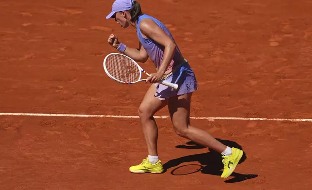 Poland's Iga Swiatek reacts winning a point to Romania's Jaqueline Cristian during their third round match of the French Tennis Open, at the Roland-Garros stadium, in Paris, Friday, May 30, 2025. (AP Photo/Lindsey Wasson)