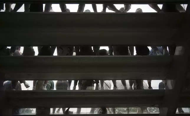 Spectators follow the third round match of the French Tennis Open between Spain's Paula Badosa and Australia's Daria Kasatkina, at the Roland-Garros stadium, in Paris, Saturday, May 31, 2025. (AP Photo/Christophe Ena)