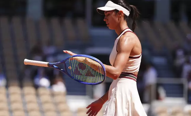Serbia's Olga Danilovic plays with her racket as she takes on Aryna Sabalenka of Belarus during their third round match of the French Tennis Open, at the Roland-Garros stadium, in Paris, Friday, May 30, 2025. (AP Photo/Lindsey Wasson)