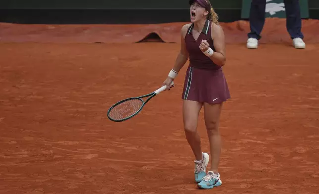 Russia's Mirra Andreeva reacts winning a point to Kazakhstan's Yulia Putintseva during their third round match of the French Tennis Open, at the Roland-Garros stadium, in Paris, Saturday, May 31, 2025. (AP Photo/Thibault Camus)