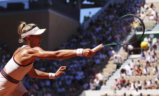 Romania's Jaqueline Cristian returns the ball to Poland's Iga Swiatek during their third round match of the French Tennis Open, at the Roland-Garros stadium, in Paris, Friday, May 30, 2025. (AP Photo/Lindsey Wasson)
