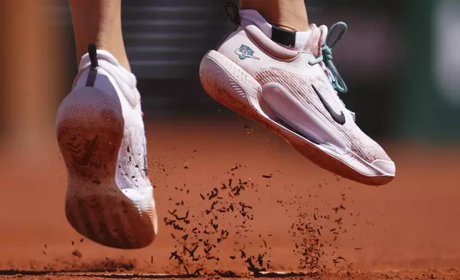 Aryna Sabalenka of Belarus kicks the clay as she plays Serbia's Olga Danilovic during their third round match of the French Tennis Open, at the Roland-Garros stadium, in Paris, Friday, May 30, 2025. (AP Photo/Lindsey Wasson)