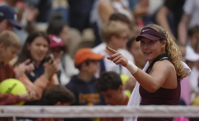 Russia's Mirra Andreeva celebrates beating Kazakhstan's Yulia Putintseva following their third round match of the French Tennis Open, at the Roland-Garros stadium, in Paris, Saturday, May 31, 2025. (AP Photo/Thibault Camus)