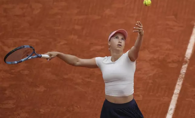 Kazakhstan's Yulia Putintseva serves the ball to Russia's Mirra Andreeva during their third round match of the French Tennis Open, at the Roland-Garros stadium, in Paris, Saturday, May 31, 2025. (AP Photo/Thibault Camus)