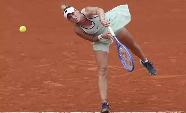 Marketa Vondrousova of the Czech Republic serves against Jessica Pegula of the U.S. during their third round match of the French Tennis Open, at the Roland-Garros stadium, in Paris, Saturday, May 31, 2025. (AP Photo/Christophe Ena)