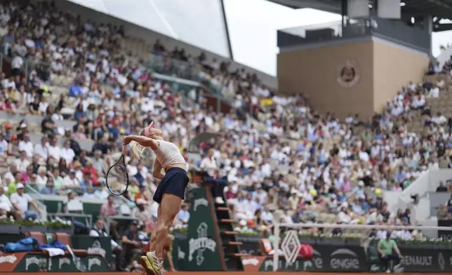 Kazakhstan's Yulia Putintseva serves the ball to Russia's Mirra Andreeva during their third round match of the French Tennis Open, at the Roland-Garros stadium, in Paris, Saturday, May 31, 2025. (AP Photo/Thibault Camus)