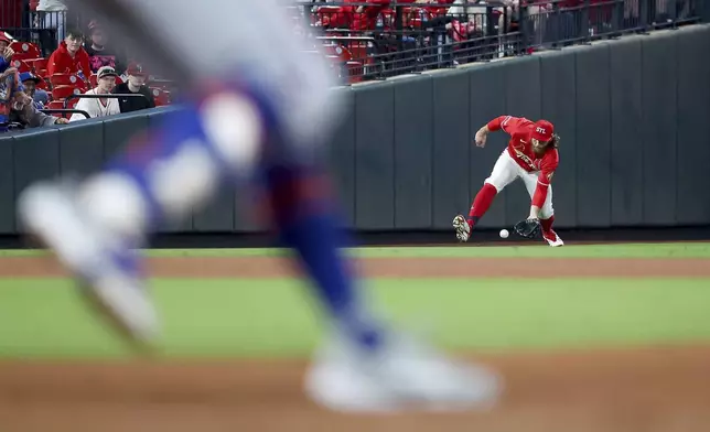St. Louis Cardinals' Brendan Donovan fields a ball hit by New York Mets' Brandon Nimmo during the fifth inning of a baseball game Friday, May 2, 2025, in St. Louis. (AP Photo/Scott Kane)