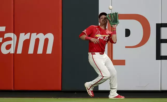 St. Louis Cardinals' Lars Nootbaar catches a sacrifice fly hit by New York Mets' Luisangel Acuña during the ninth inning of a baseball game Friday, May 2, 2025, in St. Louis. (AP Photo/Scott Kane)