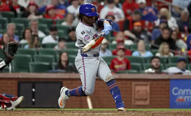 New York Mets' Luisangel Acuña hits a sacrifice fly during the ninth inning of a baseball game against the St. Louis Cardinals, Friday, May 2, 2025, in St. Louis. (AP Photo/Scott Kane)
