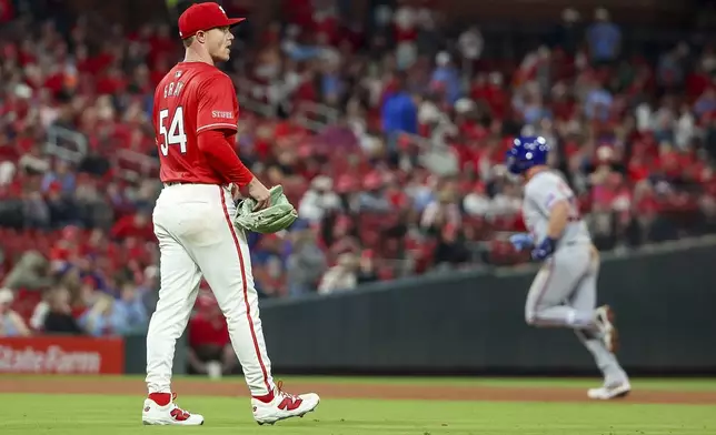 St. Louis Cardinals starting pitcher Sonny Gray, left, walks behind the mound after giving up a two-run home run to New York Mets' Pete Alonso during the fifth inning of a baseball game Friday, May 2, 2025, in St. Louis. (AP Photo/Scott Kane)