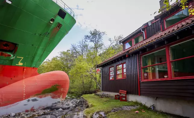 The container ship NCL Salten is seen next to Johan Helberg's house, after the 135-meter-long ship ran aground almost hitting it, in the Trondheimsfjord outside Byneset, in Trondheim, Norway, Thursday May 22, 2025. (Jan Langhaug/NTB Scanpix via AP)