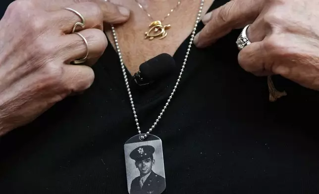 Diane Christie wears a necklace with a photograph of her uncle, World War II U.S. Army Air Forces 2nd Lt. Thomas Kelly, inside Santos Robinson Mortuary, Friday, May 23, 2025, in San Leandro, Calif., whose remains had been missing since being killed when the World War II bomber nicknamed Heaven Can Wait was hit by anti-aircraft fire and crashed into the water off the coast of New Guinea on March 11, 1944. (AP Photo/Godofredo A. Vásquez)