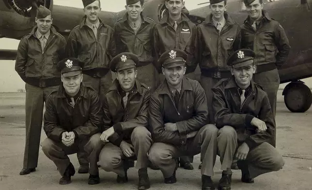 This 1943 photo shows 10 of the 11 members of the crew of the World War II B-24 bomber, Heaven Can Wait, that went down in the waters of Hansa Bay, Papua New Guinea in 1944, including Staff Sgt. Eugene Darrigan, top row second from right, and, bottom row from left, 2nd Lt. Donald Sheppick, 1st Lt. Herbert Tennyson, and 2nd Lt. Tomas Kelly, far right. (Defense POW/MIA Accounting Agency via AP)