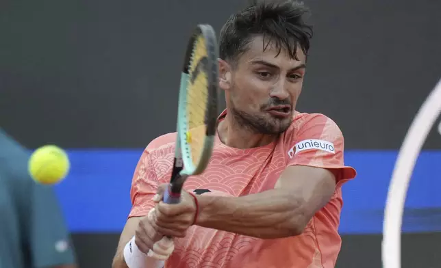 Argentina's Mariano Navone hits a return shot against Italy's Jannik Sinner during their second round match at the Italian Open tennis tournament in Rome, Saturday, May 10, 2025. (AP Photo/Andrew Medichini)