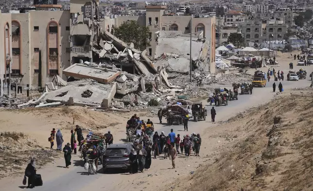 Displaced Palestinians flee from Khan Younis, Gaza, amid the ongoing Israeli military offensive in the area, on Monday, May 19, 2025. (AP Photo/Abdel Kareem Hana)