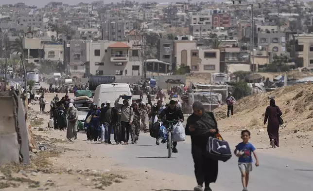 Displaced Palestinians flee from Khan Younis, Gaza, amid the ongoing Israeli military offensive in the area, on Monday, May 19, 2025. (AP Photo/Abdel Kareem Hana)