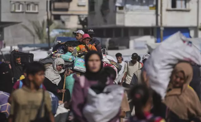 Displaced Palestinians flee from Khan Younis, Gaza, amid the ongoing Israeli military offensive in the area, on Monday, May 19, 2025. (AP Photo/Abdel Kareem Hana)