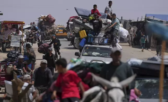 Displaced Palestinians flee from Khan Younis, Gaza, amid the ongoing Israeli military offensive in the area, on Monday, May 19, 2025. (AP Photo/Abdel Kareem Hana)
