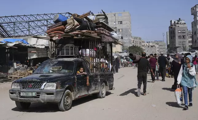 Displaced Palestinians flee from Khan Younis, Gaza, amid the ongoing Israeli military offensive in the area, on Monday, May 19, 2025. (AP Photo/Abdel Kareem Hana)