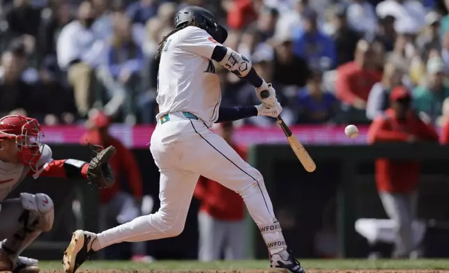 Seattle Mariners' J.P. Crawford hits a two RBI single against the Los Angeles Angels during the seventh inning of a baseball game, Wednesday, April 30, 2025, in Seattle. (AP Photo/John Froschauer)