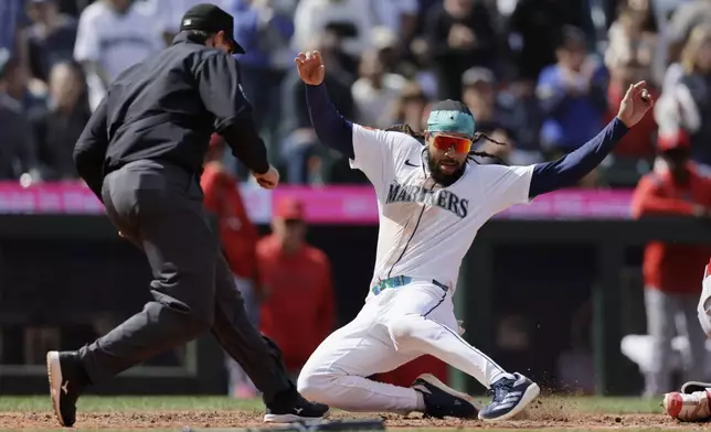 Seattle Mariners' J.P. Crawford scores against the Los Angeles Angels during the seventh inning of a baseball game, Wednesday, April 30, 2025, in Seattle. (AP Photo/John Froschauer)